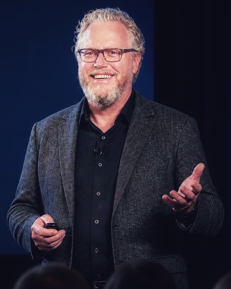 Ron Hollis speaking on stage